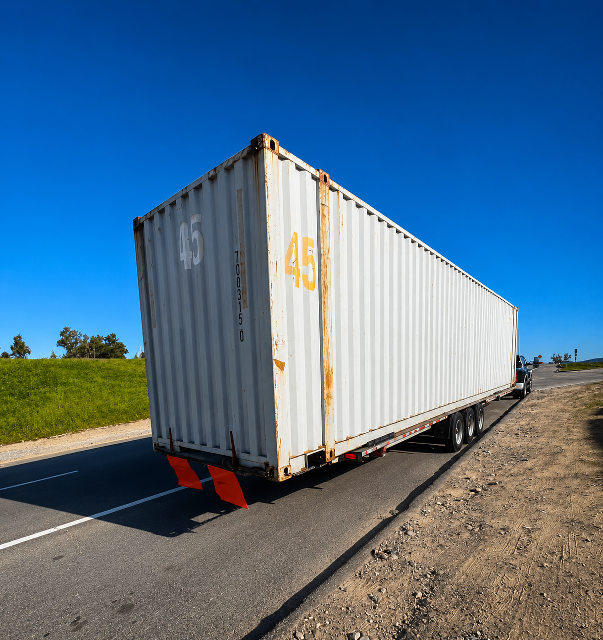 Container loaded for relocation on a trailer
